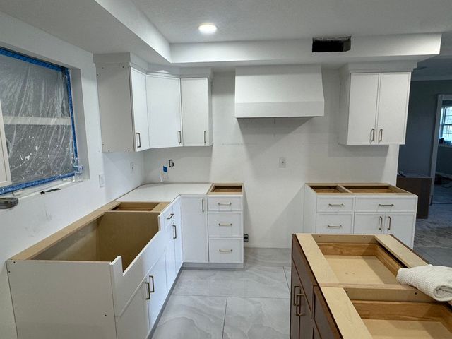 Kitchen cabinets and island installation in progress.